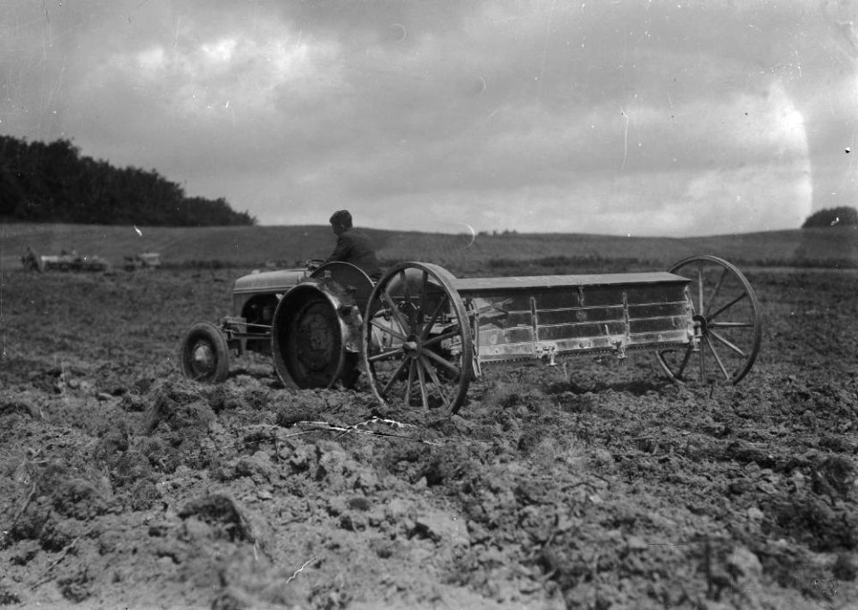 Man on tractor pulling agricultural implement (1294090)