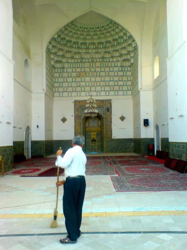 Man sweep front of iwan of Kashmar grand mosque