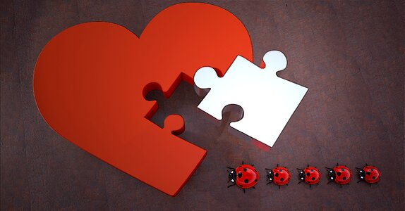 Joining together puzzle piece heart shape photo