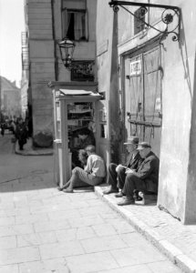Mannen op de stoep bij een krantenkiosk, Bestanddeelnr 190-0045 photo