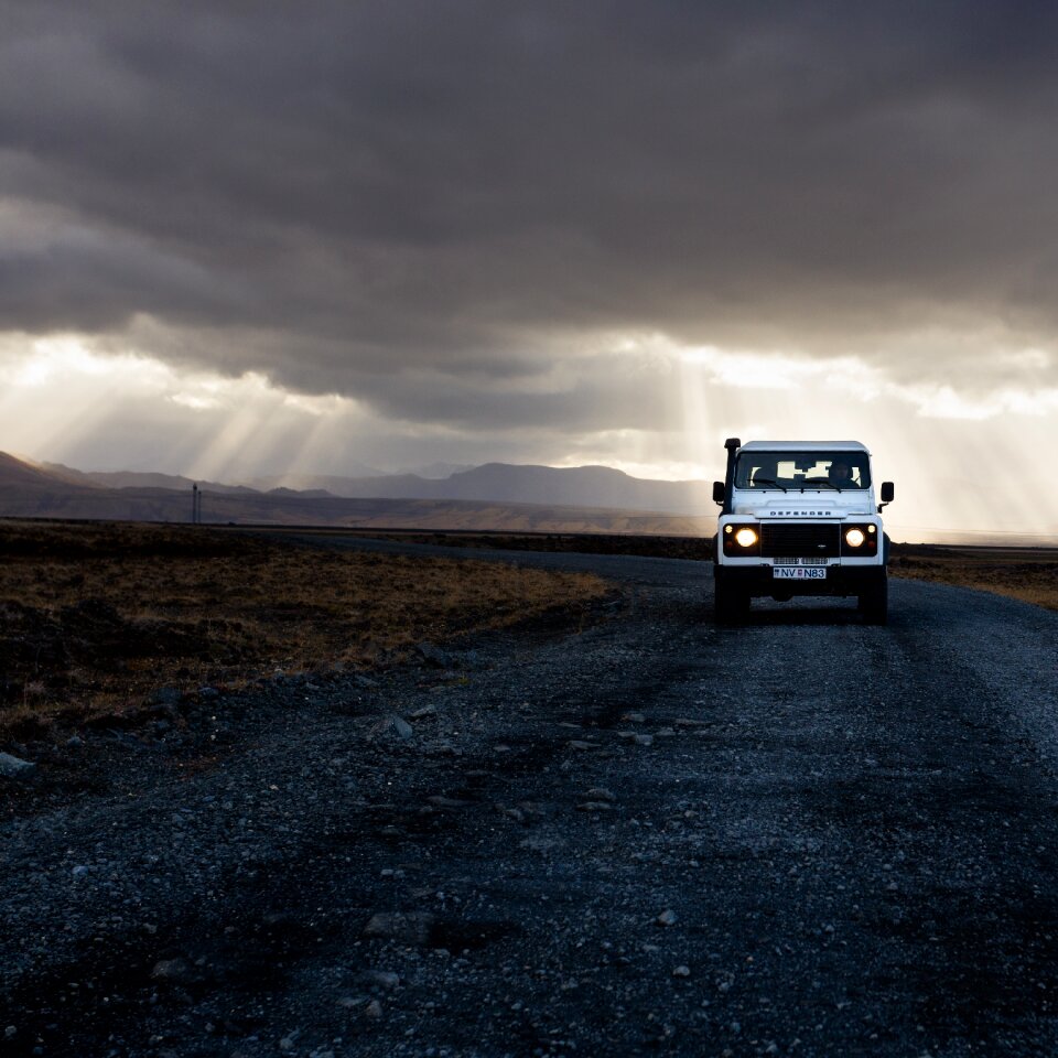 Car dark clouds desert