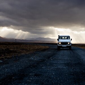 Car dark clouds desert