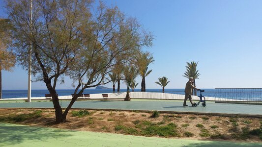 Old man walking seaview photo