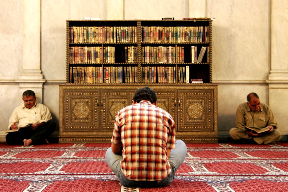 Men reading the Koran in Umayyad Mosque, Damascus, Syria