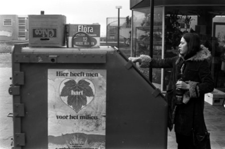 Meisje gooit fles in container ivm milieu-aktie te Amstelveen (glasinzamel-ak, Bestanddeelnr 926-1820