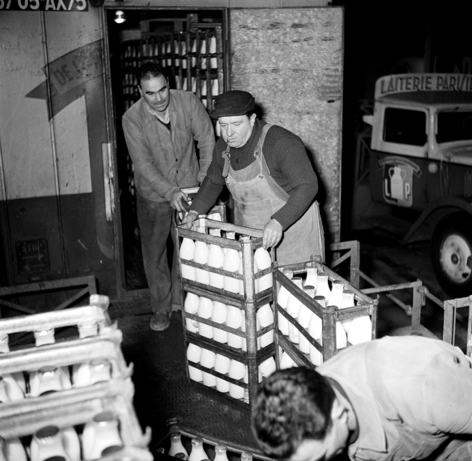 Melkfabriek mannen verslepen kratten met melkflessen, Bestanddeelnr 252-9457