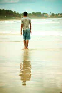 Walk alone reflect sea