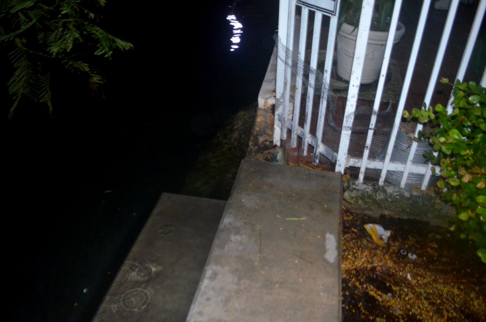 Miami Beach seawall tidal flooding with rain at high tide during king tides 21