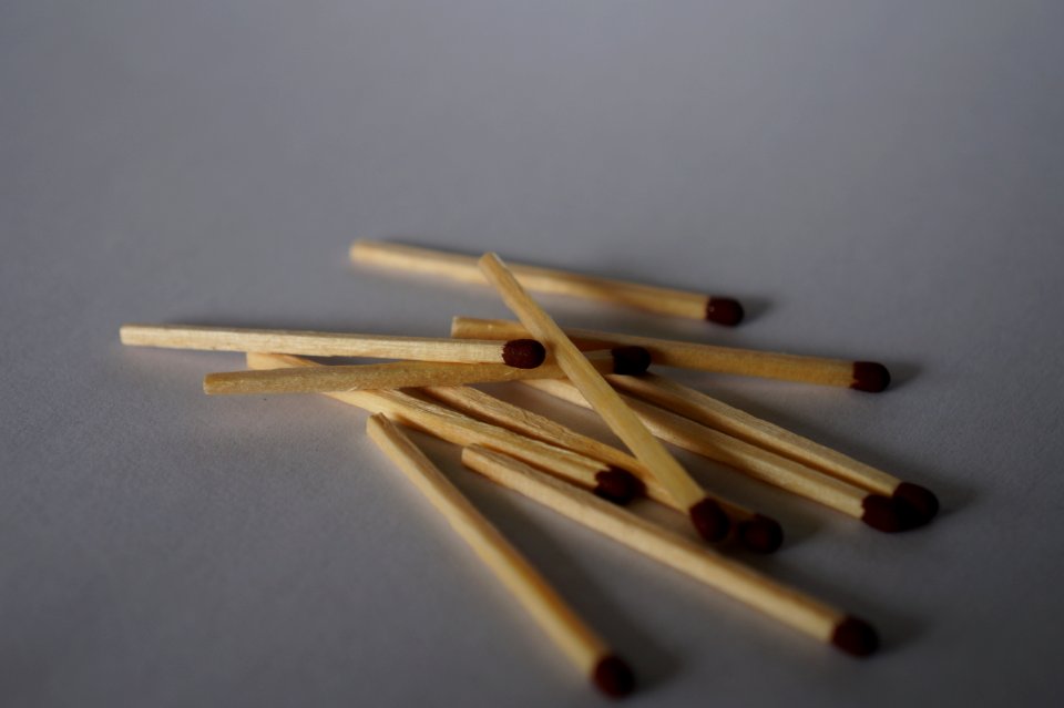Matches scattered on white background (option 1 of 2)