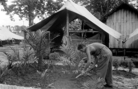 Marihat. Legerbivak een militair bezig in een plantsoentje met palmbomen, Bestanddeelnr 2155