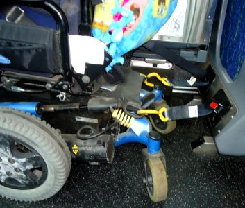 Mechanism to hook wheelchair to bus