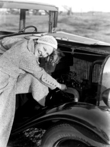Model Eva Waldschmidt kijkt onder de motorkap van een auto, Bestanddeelnr 189-0298