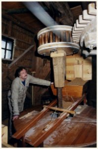 Molen de Zandhaas maalt weer op wind. Foto Molenaar Jos Kors bij de nieuwe pasbalk vervaardigd uit de stronk van een omgewaaide oude eik. NL-HlmNHA 54050177