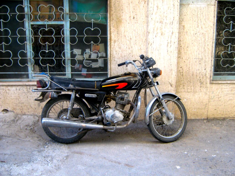 Motorcycle near wall parked - alley in Shariati st - Nishapur