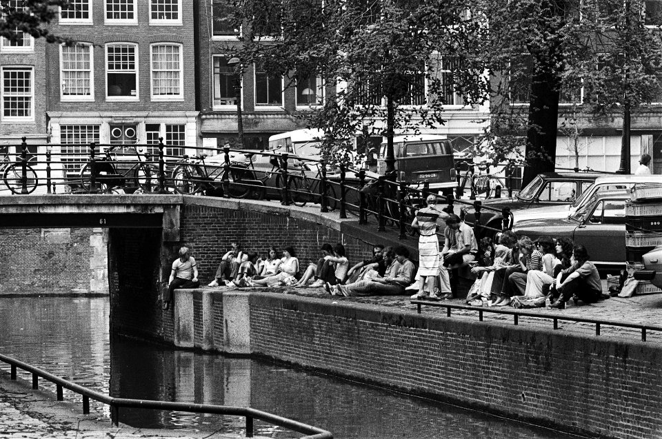 Mooi weer in Amsterdam zonnende mensen langs de wallekant van de Leliegracht, Bestanddeelnr 930-2648