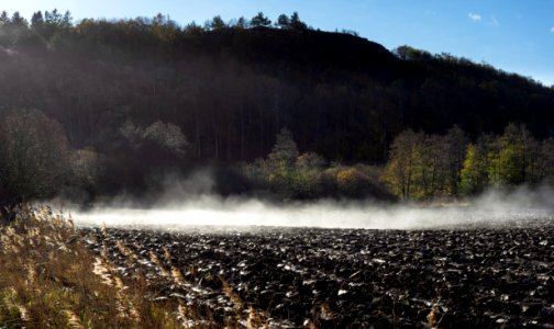 Morning mist lifting from plowed field 1
