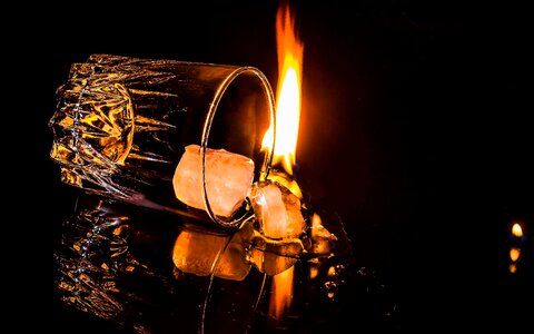 Flame fallen over glass spilled alcohol