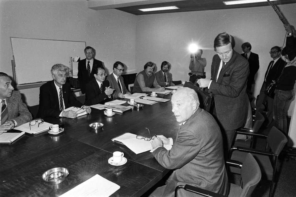 Ministers Terlouw (staand, rechts) en Den Uyl (zittend) aan de overkant van de , Bestanddeelnr 931-7251