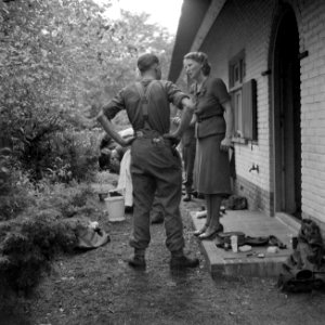 Militair van de Irish Guards in gesprek met inwoonster van Aalst, met op de acht, Bestanddeelnr 255-9032
