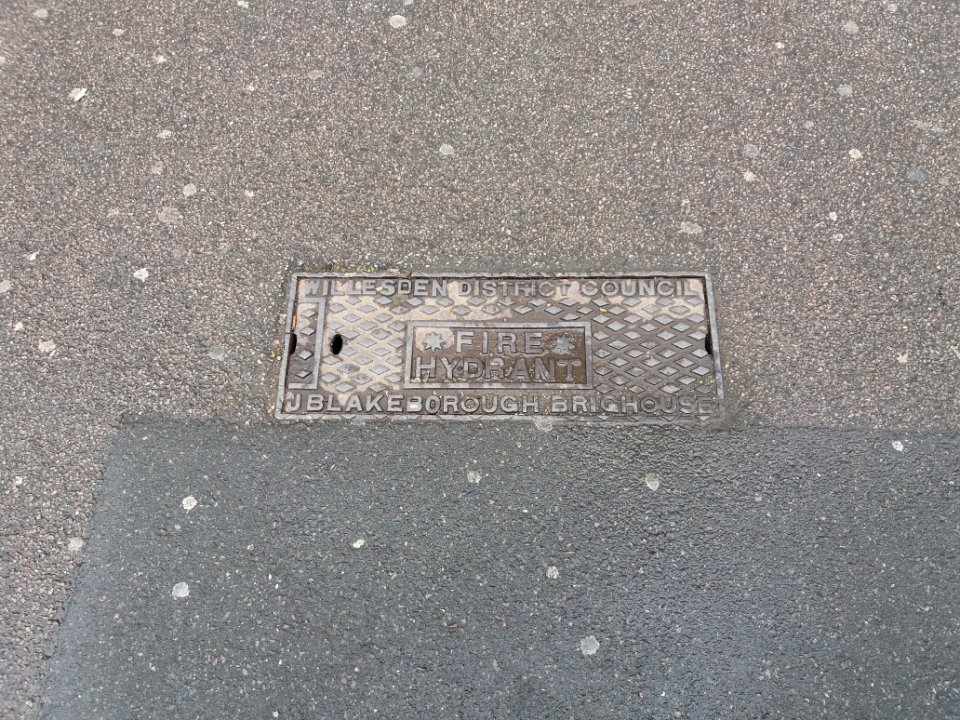 Neasden - Neasden Lane, fire hydrant plaque on the pavement