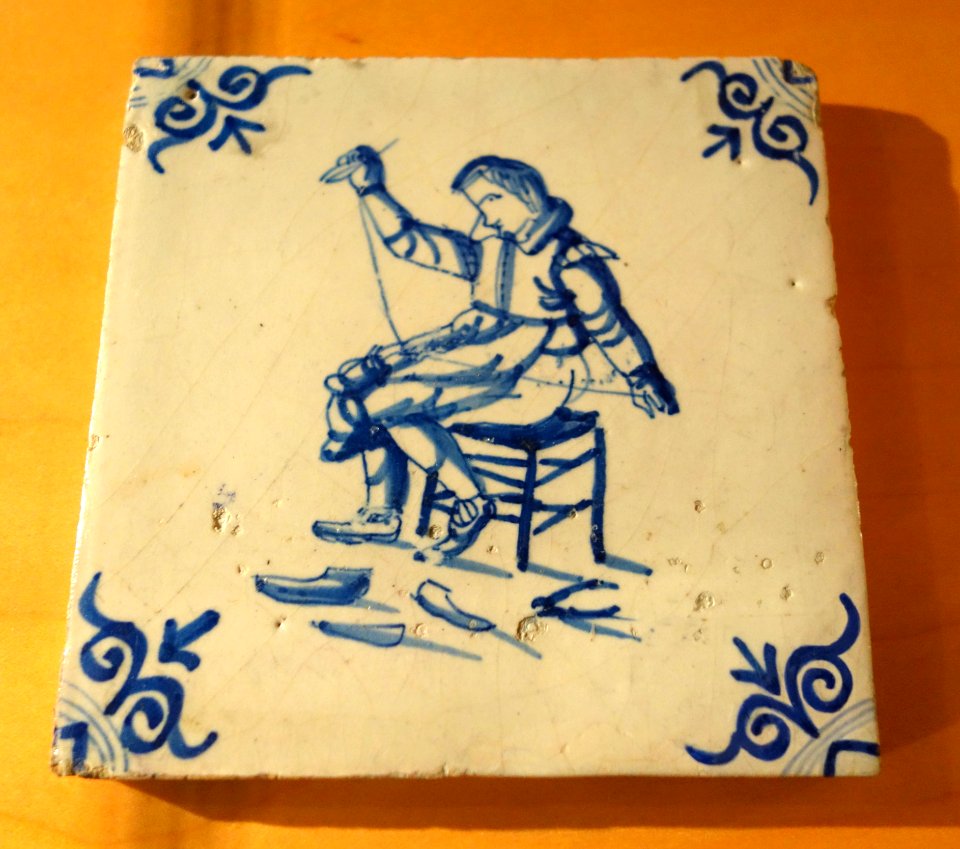 Netherlands tile depicting shoemaker stitching footware, 2 of 2, c. 1630, ceramic - Bata Shoe Museum - DSC00293