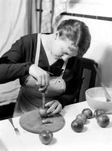 Nell Langlais snijdt met een appelboor de klokhuizen uit de appels voor de appel, Bestanddeelnr 189-1082