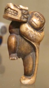 Netsuke of monkey holding lion mask, Honolulu Museum of Art photo