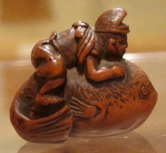 Netsuke with man riding a blowfish, Honolulu Museum of Art