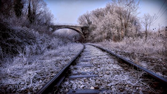 Railroad tracks wintry arch bridge