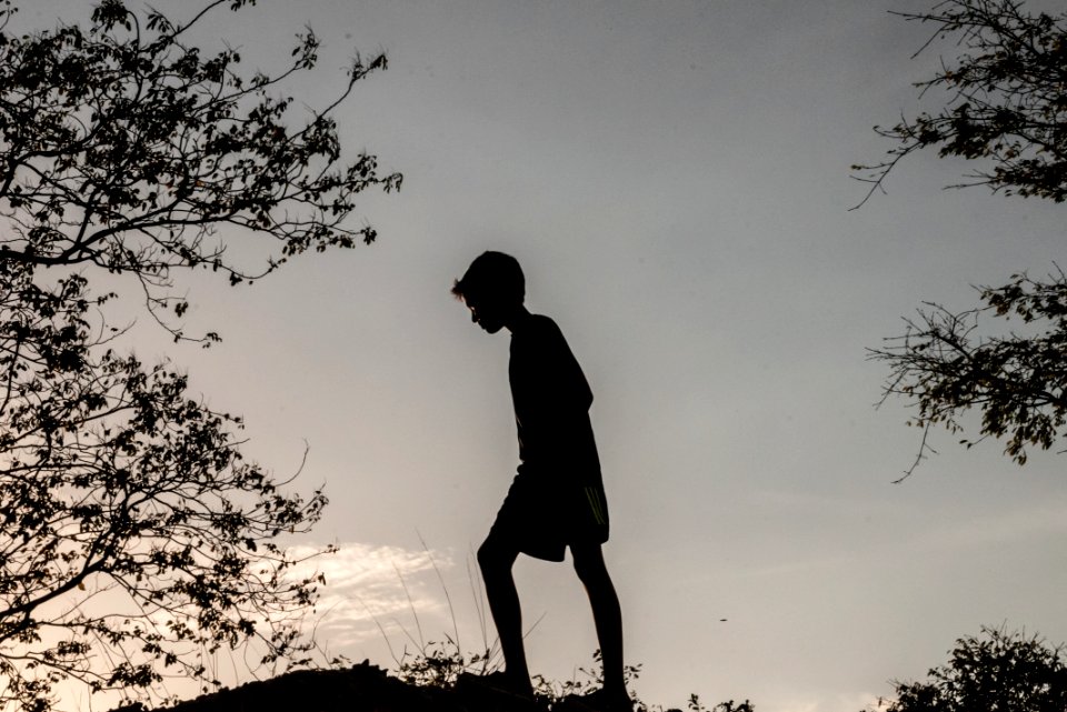Niño subiendo en contraluz