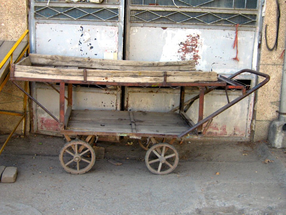 Old wooden cart - front of a garage door - 17 st - Nishapur