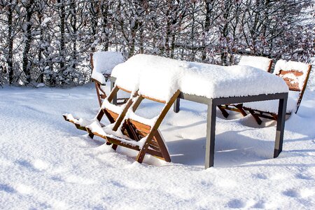Wood chairs metal table snowy photo