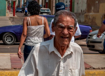 Old man walking down in Maracaibo center