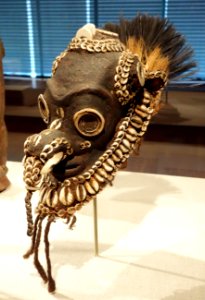 Ornament for sacred flute, East Sepik Province, lower Sepik River west of Keram River, Kambot (Tin dama) people, 19th-early 20th c., clay paste, cassowary feathers, pig tusk, hair, shell - De Young Museum - DSC01210