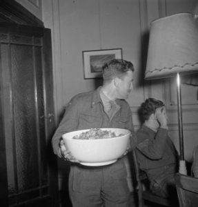 Oranjehaven, de Engelandvaarders club in Londen. Man met schaal met salade, Bestanddeelnr 935-2584