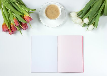 Flowers notebook work desk photo