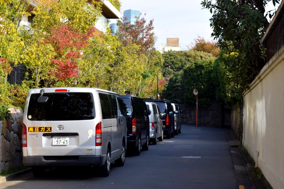 Parked procession of Toyota Hiace vans bringing workers to maintain the luxury apartment complex "Azabu Gardens"