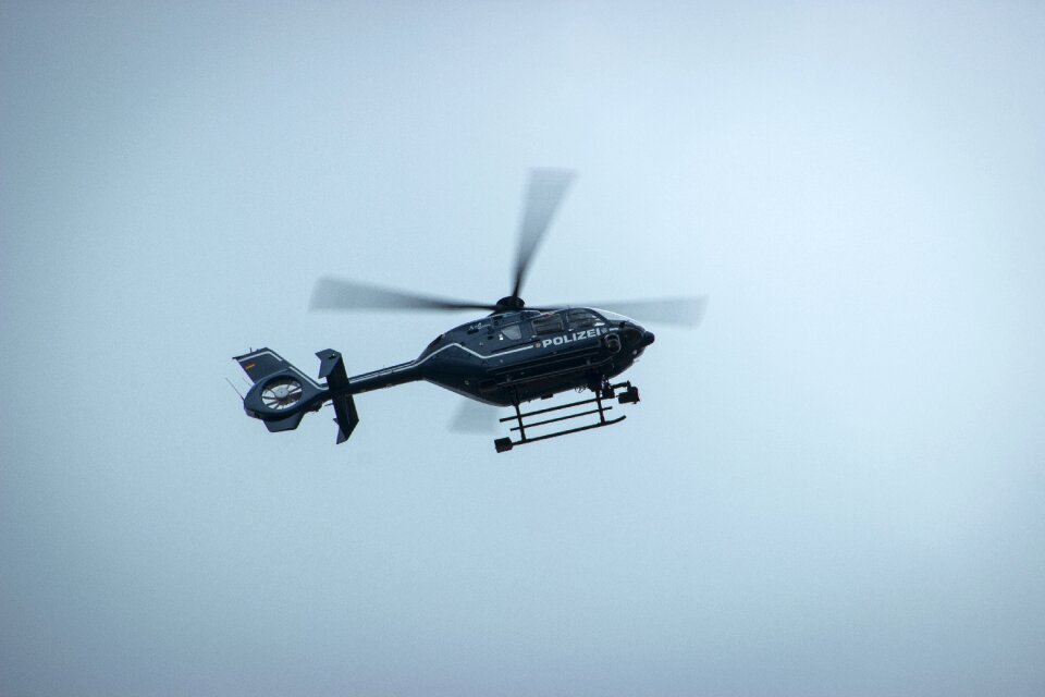 Police helicopter monitoring flying