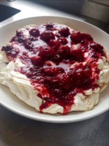 Pavlova with strawberry and raspberry coulis photo