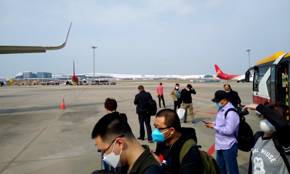 Passengers wearing masks before boarding