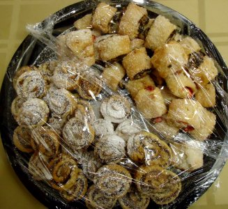 Pastries covered by plastic wrap at a party