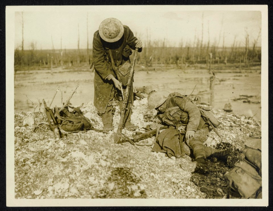 Out from the trenches, one has a rest, the other cleans his rifle, Bestanddeelnr 158-0987