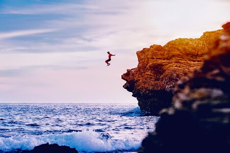 Waves man cliff diving photo