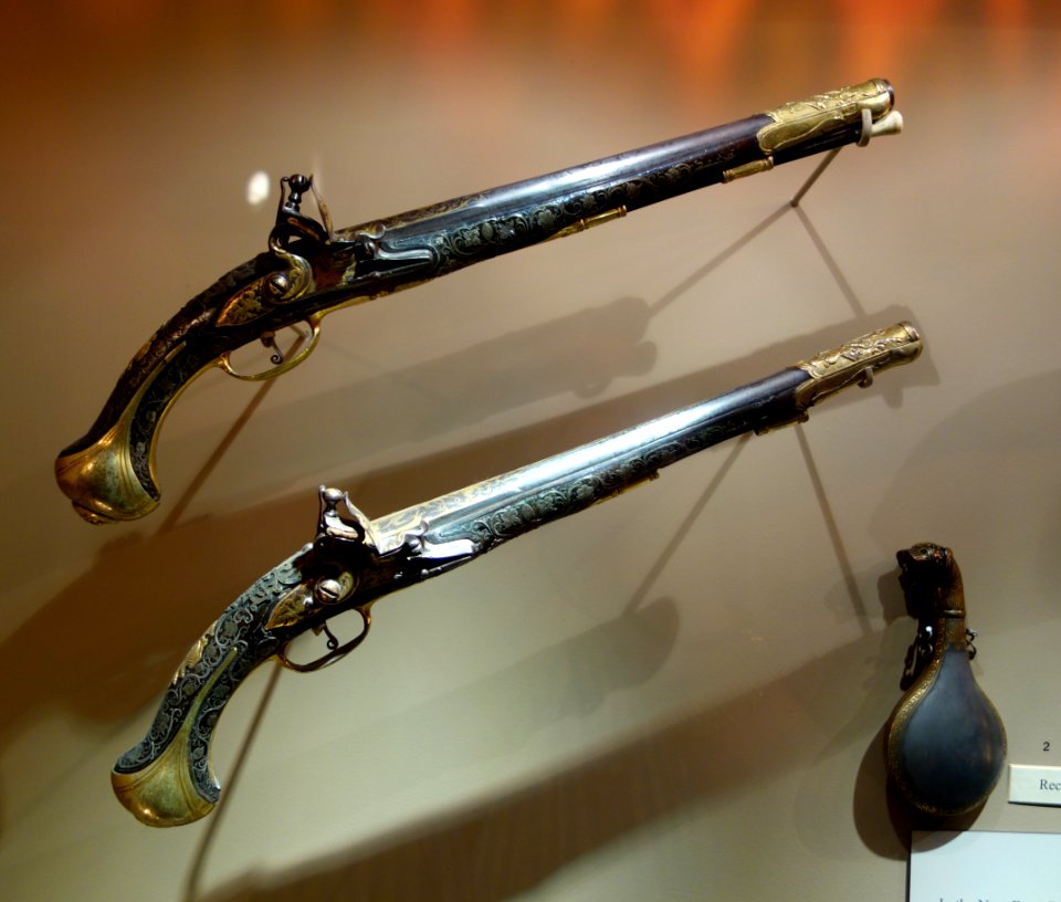 Pair of flintlock pistols, Turkey, late 18th century, with Powder flask with leopard-head finial, 19th century Damascened watered steel, glass eyes - Huntington Museum of Art - DSC04929