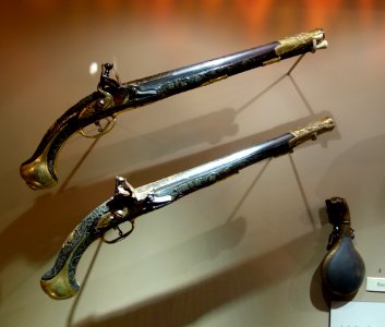 Pair of flintlock pistols, Turkey, late 18th century, with Powder flask with leopard-head finial, 19th century Damascened watered steel, glass eyes - Huntington Museum of Art - DSC04929