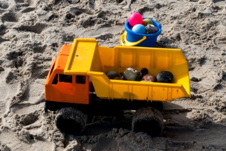 Plastic toy truck and pail in sand photo