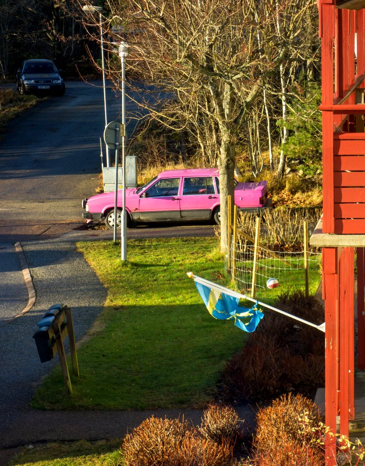 Pink Volvo and torn flag