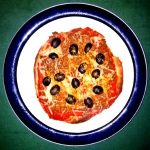 Pizza of tomato sauce, TVP, cheddar, black olives, and curry powder on soft taco - Massachusetts