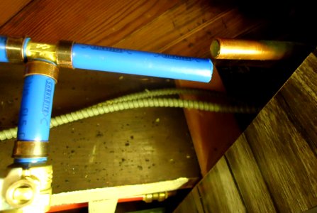 PEX pipes and valves in basement ceiling for exterior water spigot photo