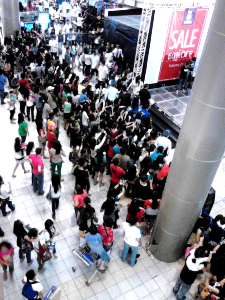 People gather at the atrium of SM City Clark for a mall event